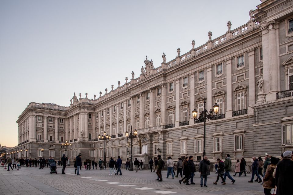 people in front of the Royal Palace at dusk