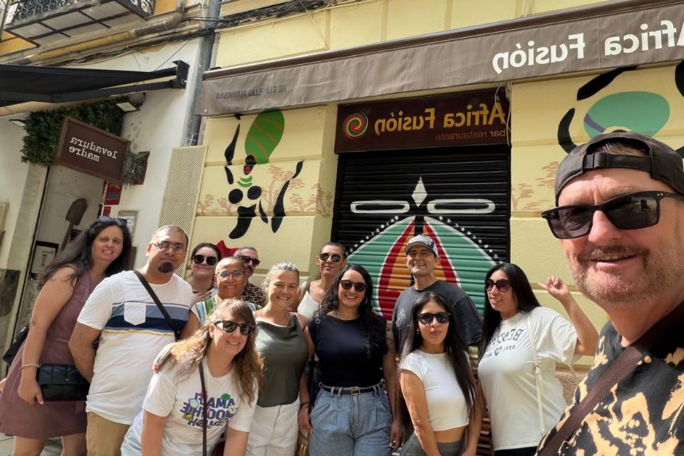 Selfie with people posing in front of an african restaurant mural