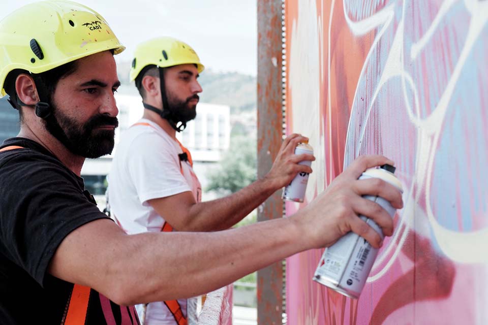 Duo of artists captured while painting with spray cans