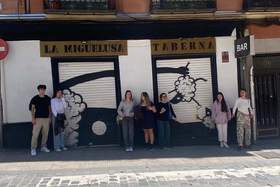students in front of a street art artwork
