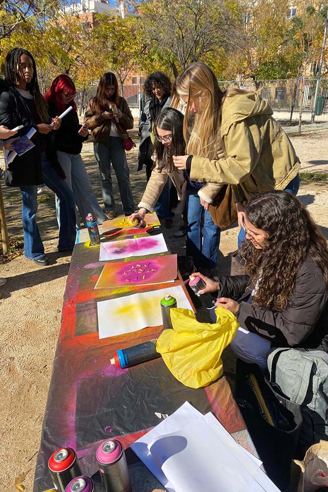 university students painting with spray cans