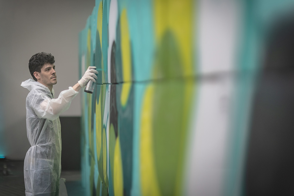 spray painting over a card board box wall