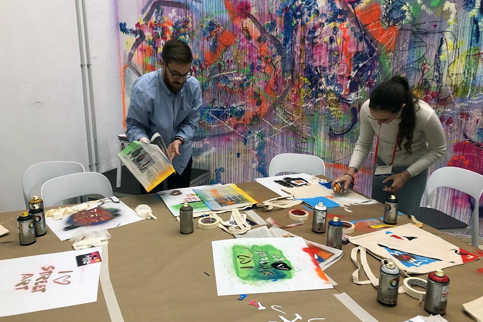 guests using spray paint at the corporate team event