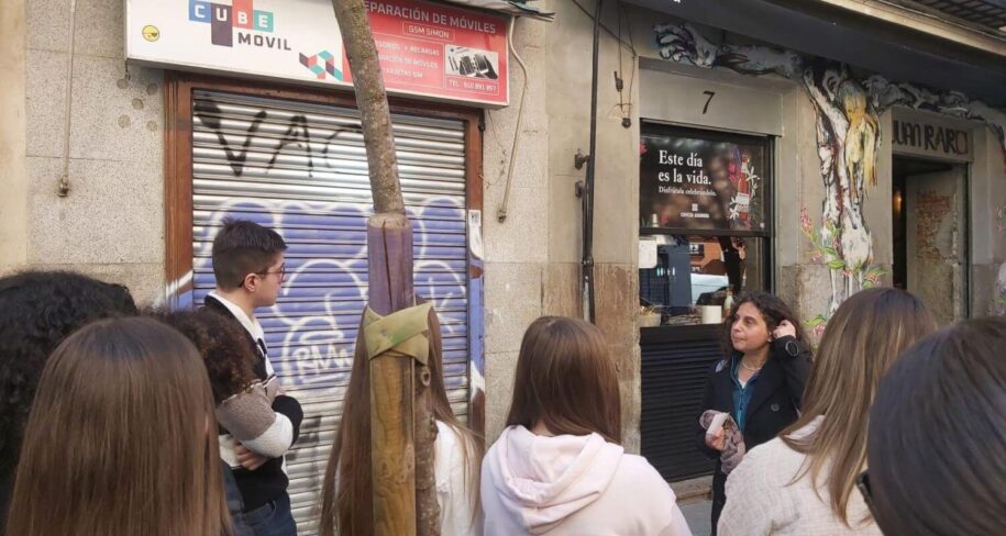 Christine explaining amazing street art by Ze Carrion to student travel agency