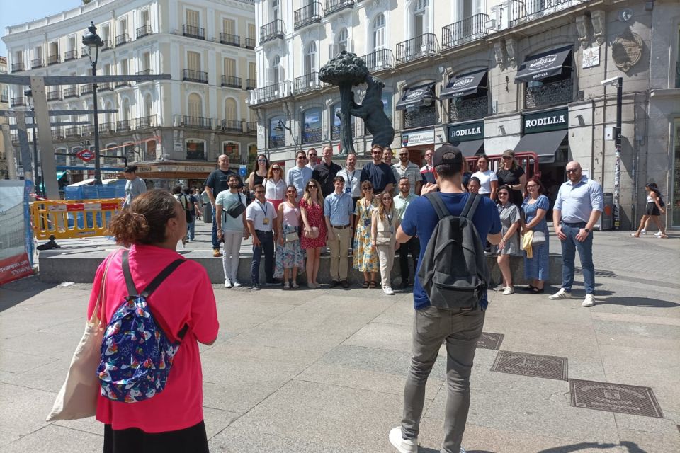 Posing in front of the bear and the tree with the student travel agency 