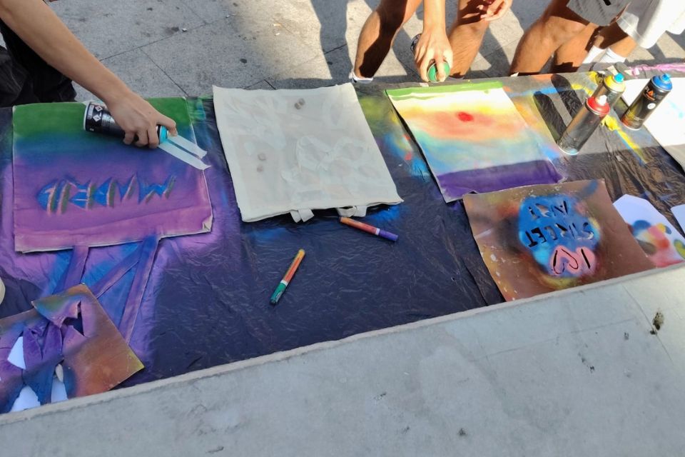 covered bench where people paint tote bags 